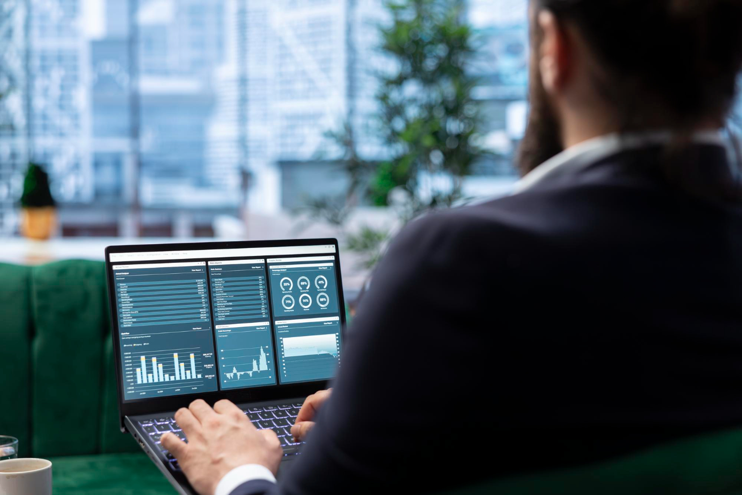 Man reviewing analytics dashboard data on laptop in office